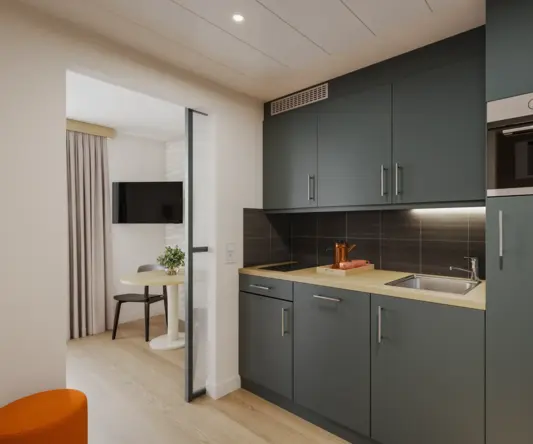 a kitchen with a table and a microwave