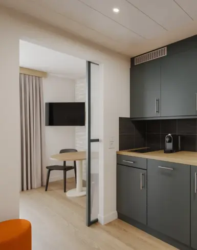 a kitchen with a table and a microwave