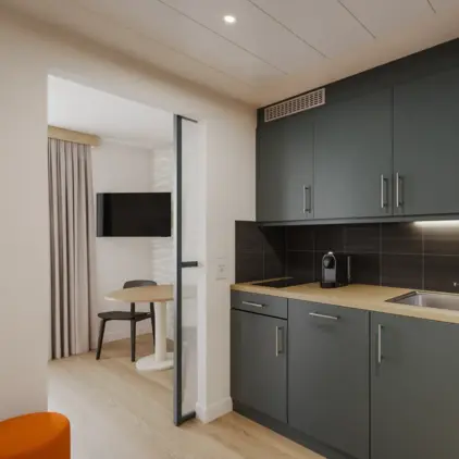 a kitchen with a table and a microwave