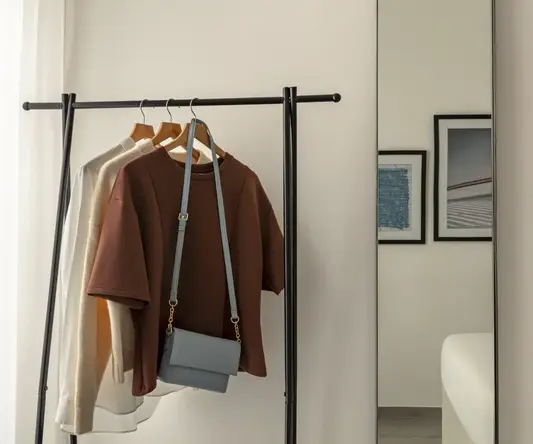 a clothes rack with a purse on it