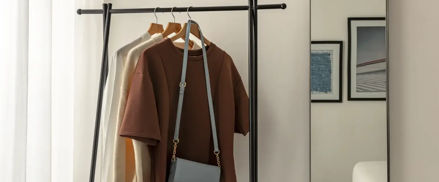 a clothes rack with a purse on it