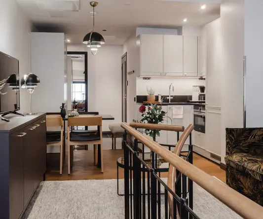 a room with a kitchen and dining area