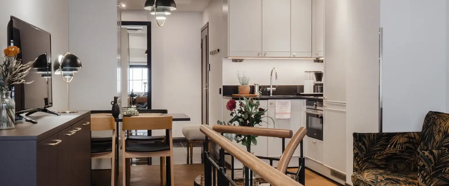 a room with a kitchen and dining area
