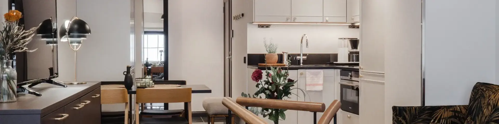 a room with a kitchen and dining area