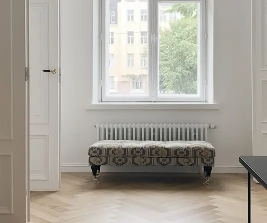 a room with a bench and a window