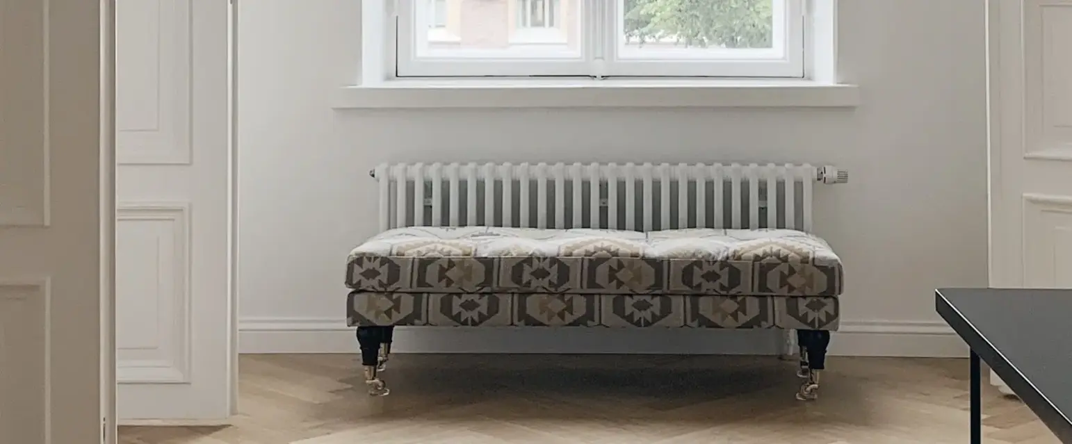 a room with a bench and a window