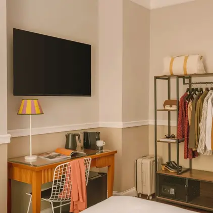 a room with a tv and a shelf