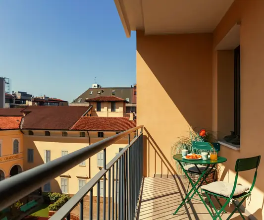 a balcony with a table and chairs