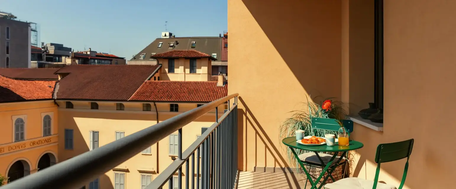 a balcony with a table and chairs