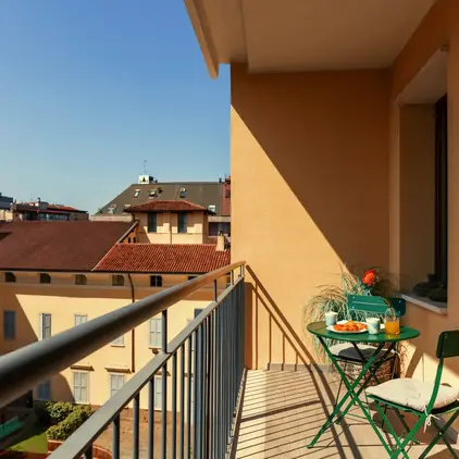 a balcony with a table and chairs