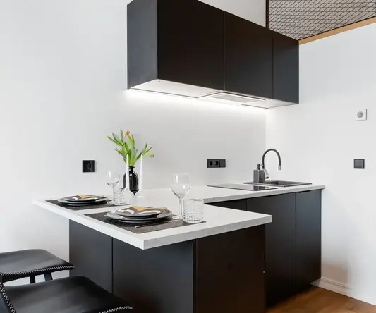 a kitchen with black cabinets and black counter tops
