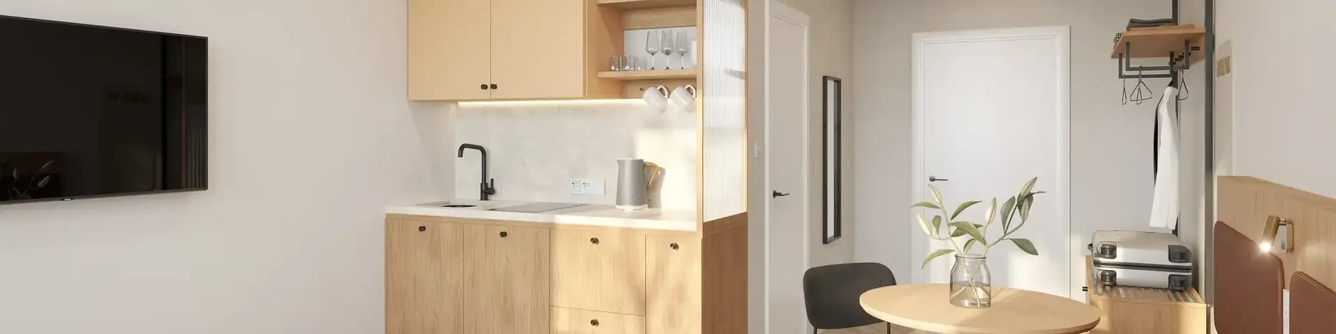 a bedroom with a kitchen and dining area