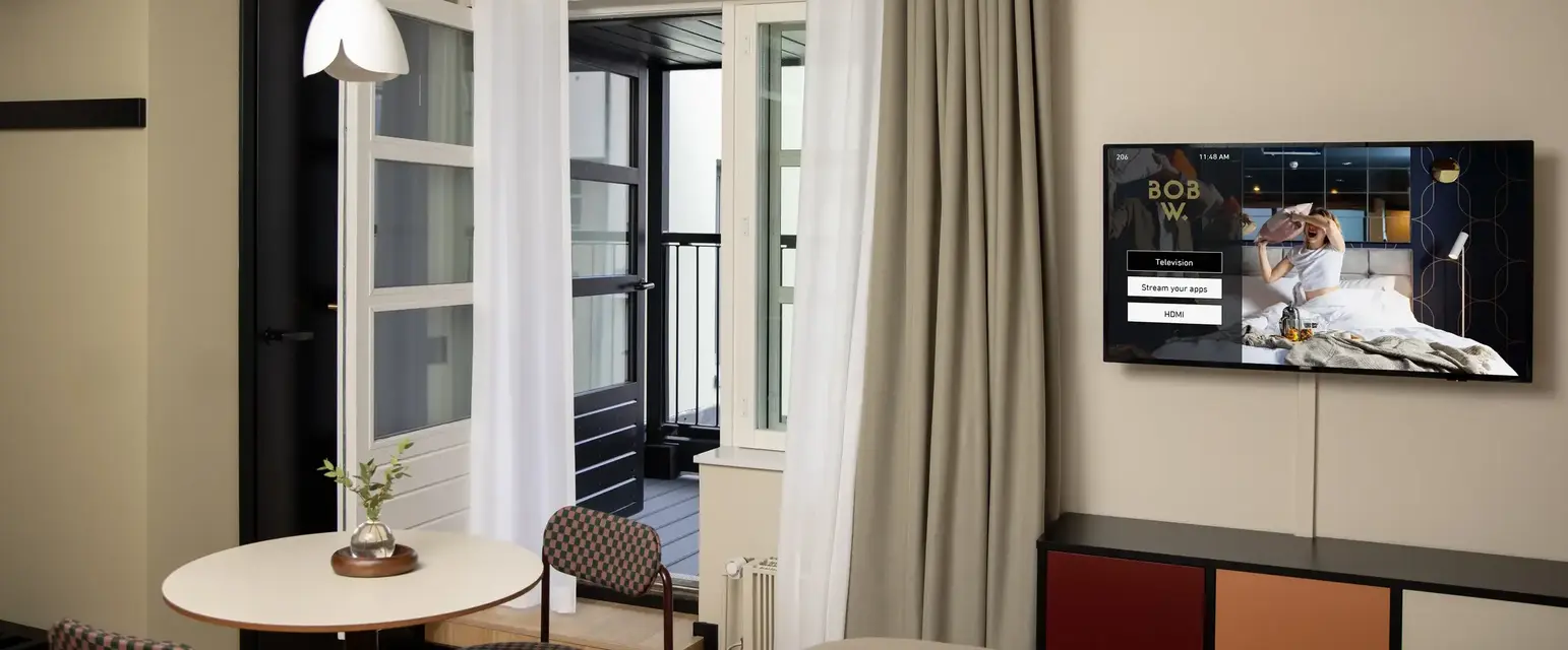 a room with a bed and a television on the wall