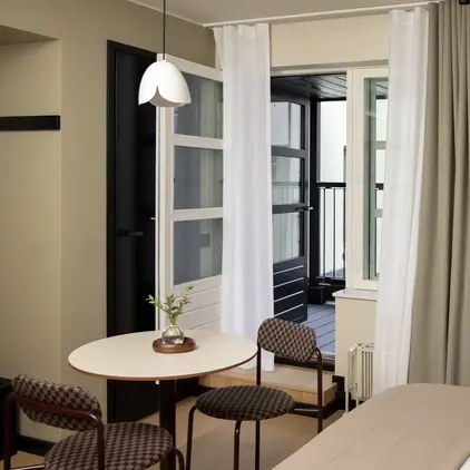 a room with a bed and a television on the wall