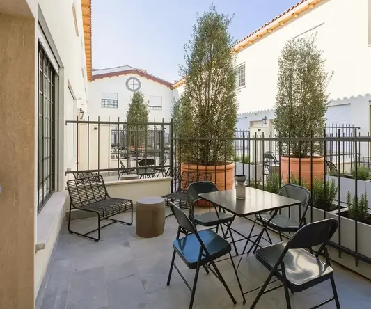 a patio with a table and chairs