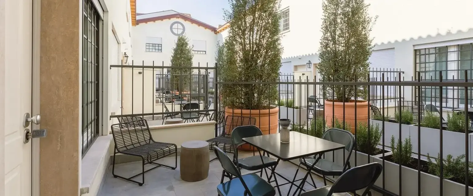 a patio with a table and chairs
