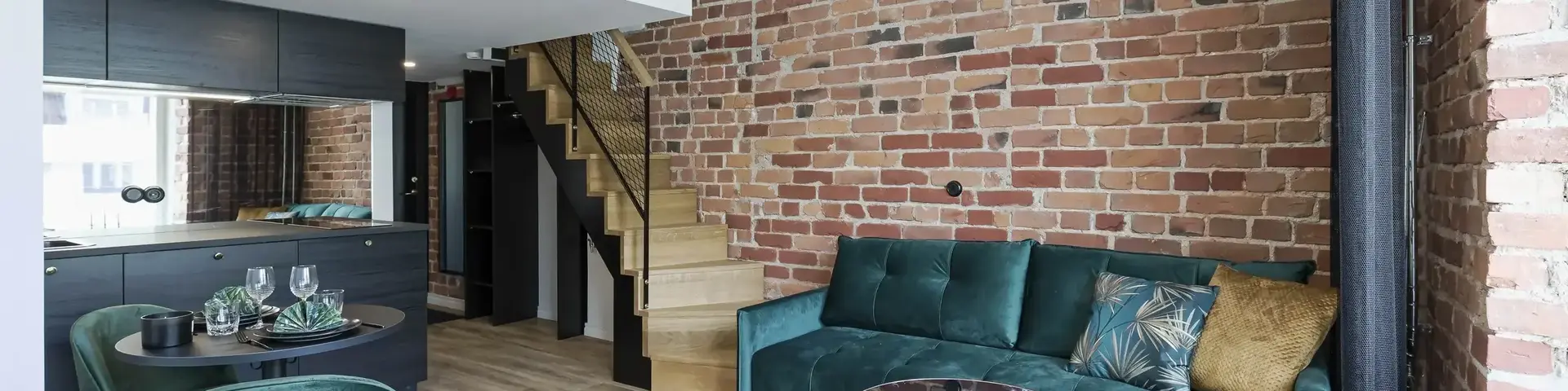 a living room with a brick wall and a couch