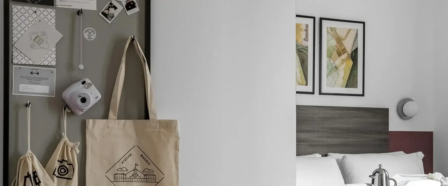 a room with a bed and a bulletin board