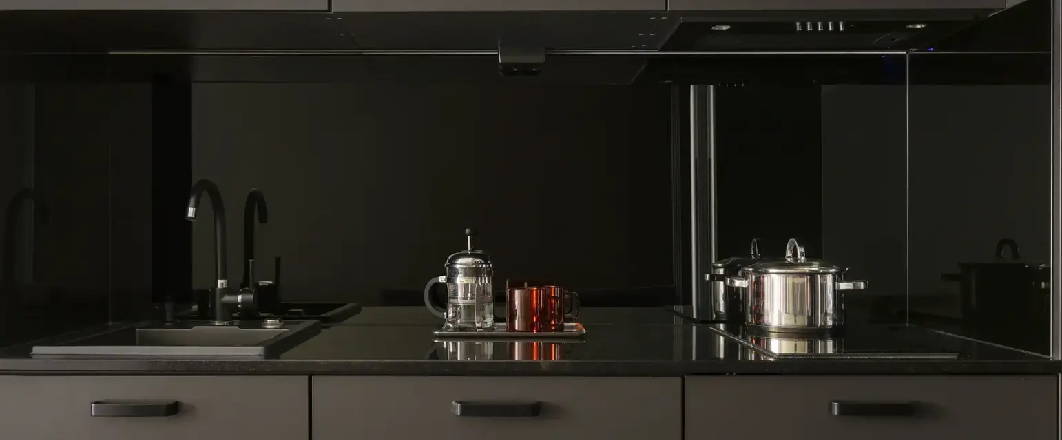 a kitchen with black cabinets and black appliances