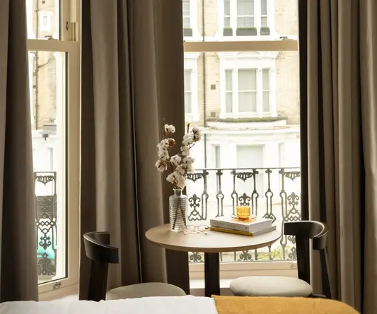 a table with a book and a vase on it