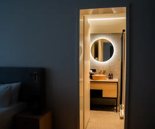 a bathroom with a round mirror
