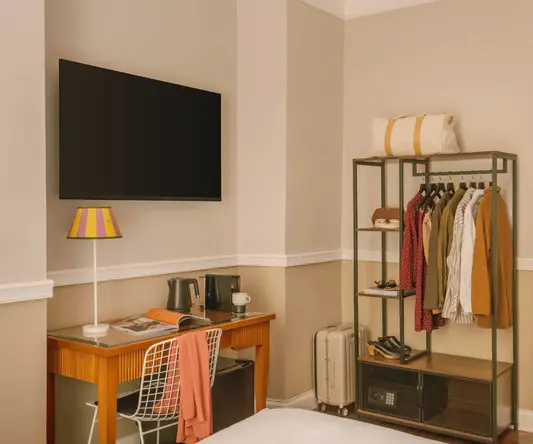 a room with a tv and a shelf
