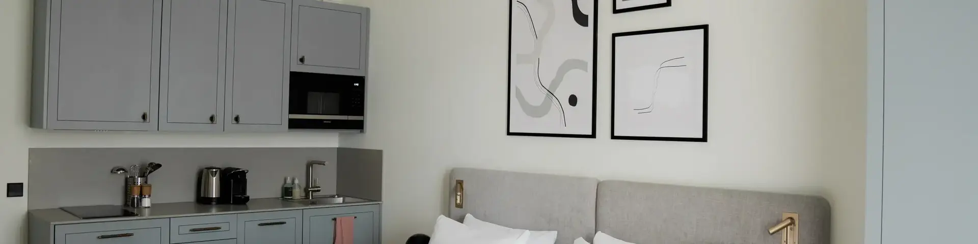 a bed with white sheets and pillows in a room