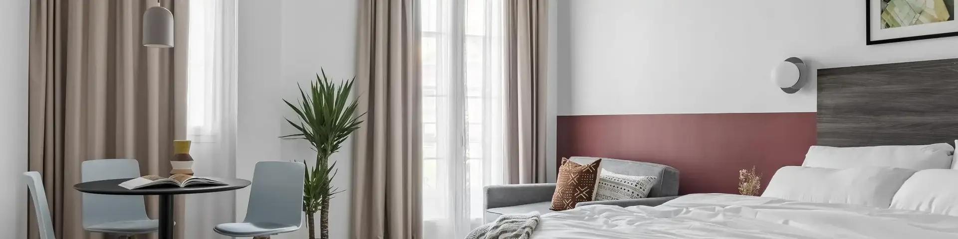 a room with a bed and a table and chairs