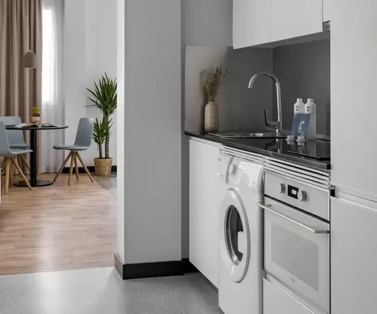 a kitchen with a washing machine and a sink
