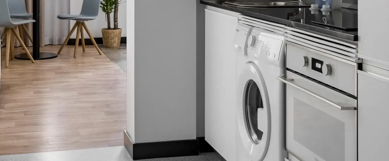 a kitchen with a washing machine and a sink