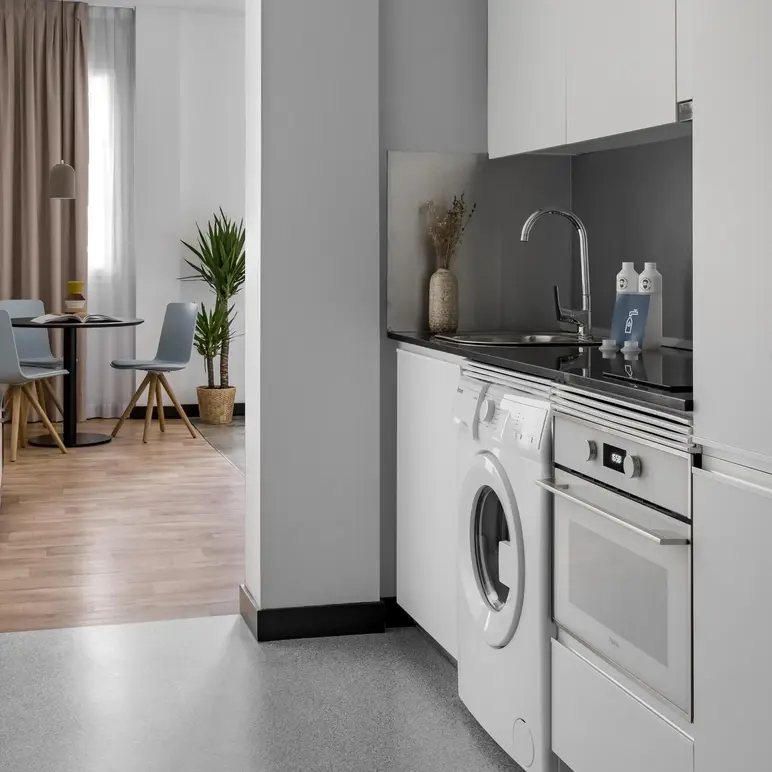 a kitchen with a washing machine and a sink