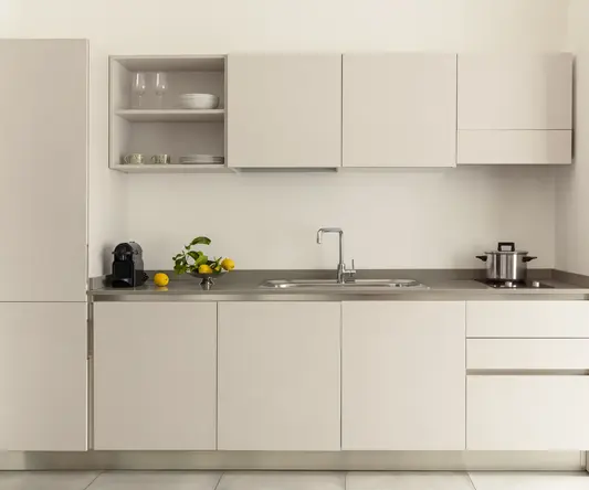 a kitchen with white cabinets and a sink