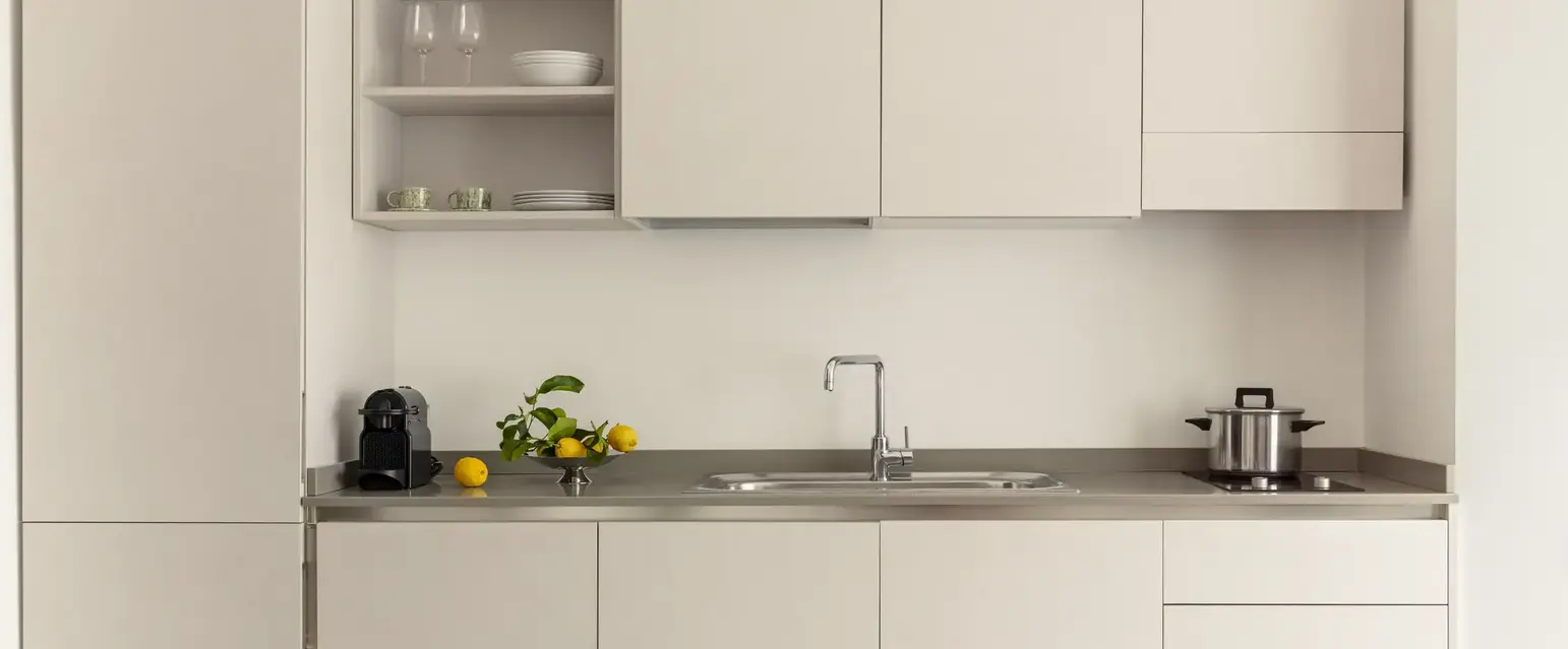 a kitchen with white cabinets and a sink