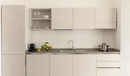 a kitchen with white cabinets and a sink