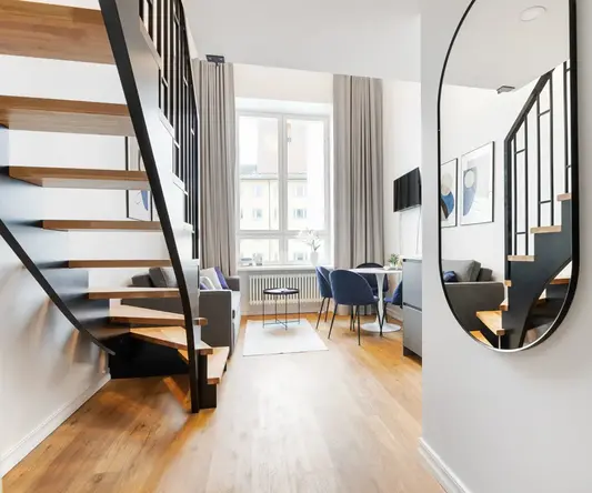 a room with a staircase and a table