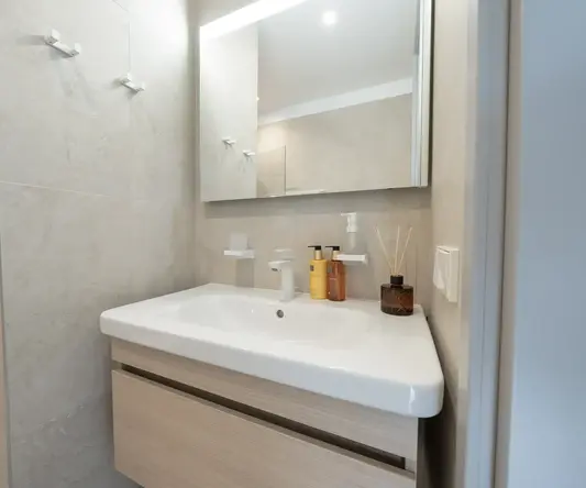a bathroom with a mirror and sink