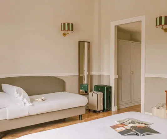 a room with a bed and luggage