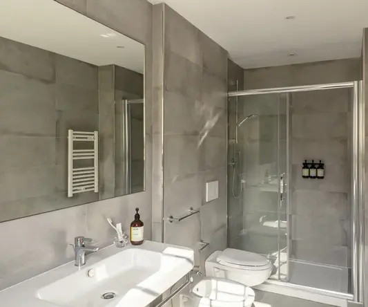 a bathroom with a shower and sink