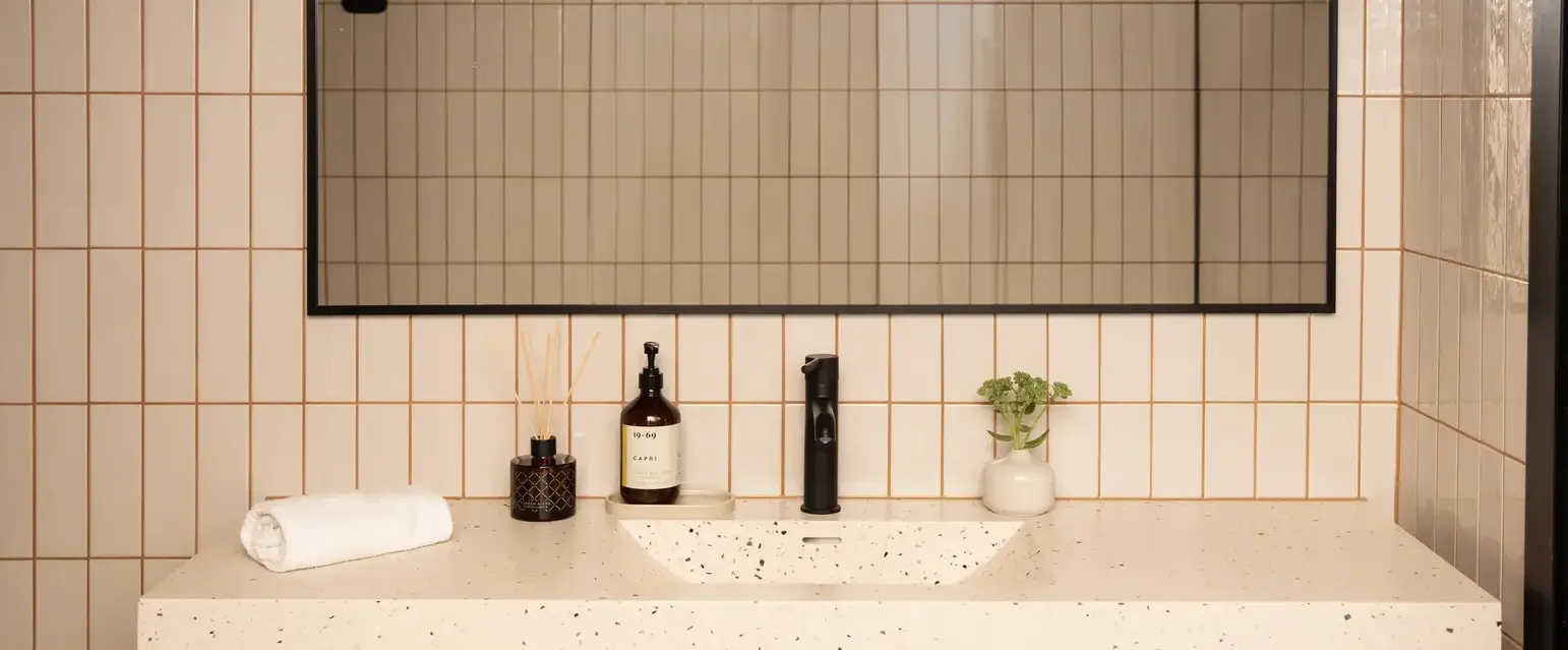 a bathroom with a mirror and sink