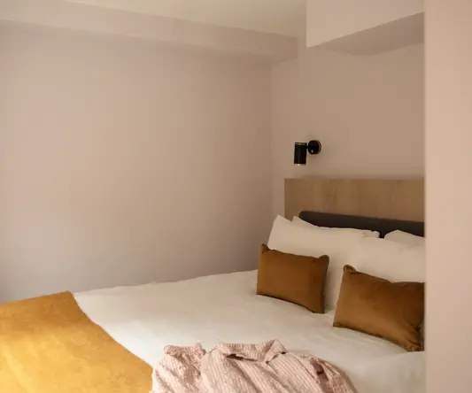 a bed with pillows and a blanket