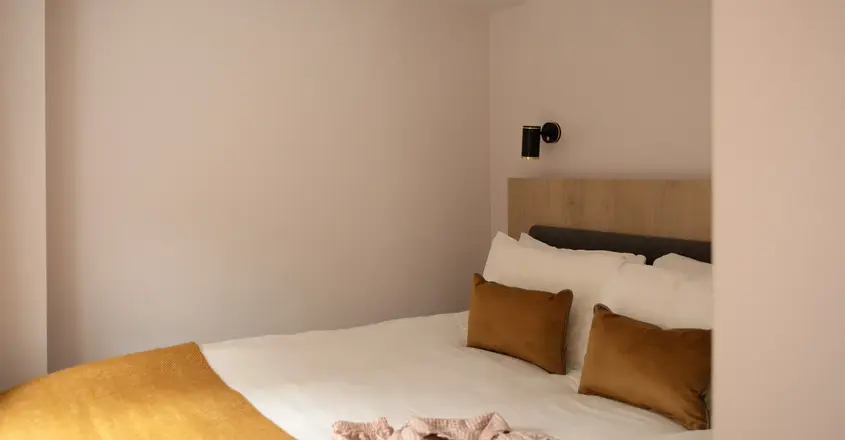 a bed with pillows and a blanket