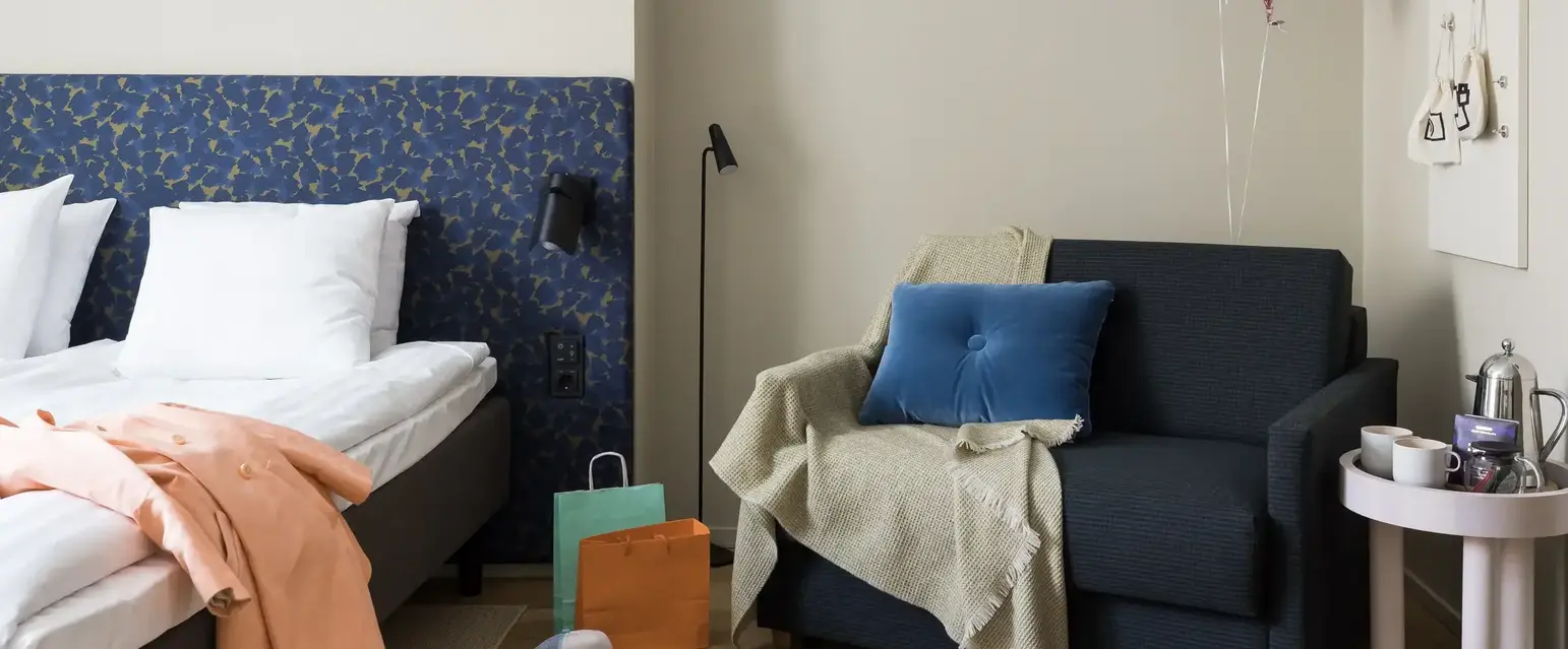 a couch with a blanket and balloons in a room