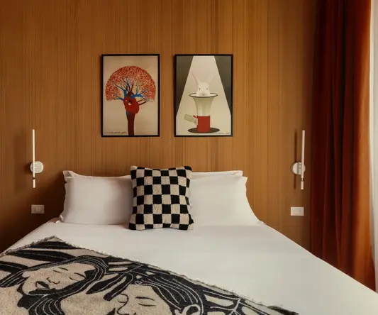 a bed with a pillow and a checkered blanket on it