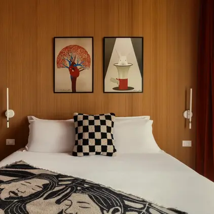 a bed with a pillow and a checkered blanket on it