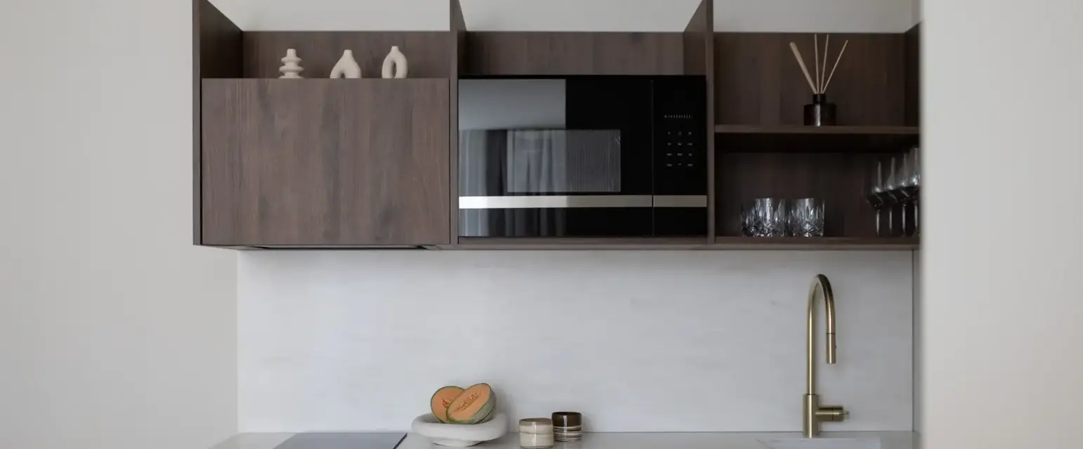 a kitchen with a microwave and a sink