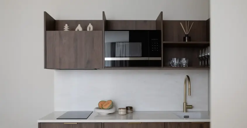 a kitchen with a microwave and a sink