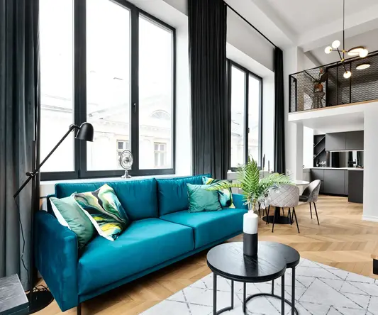 a living room with a blue couch and a table