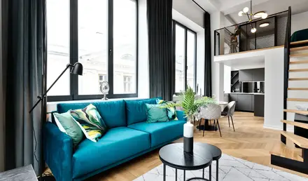 a living room with a blue couch and a table