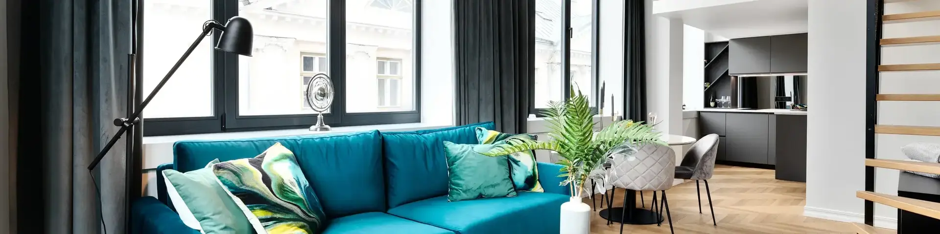 a living room with a blue couch and a table