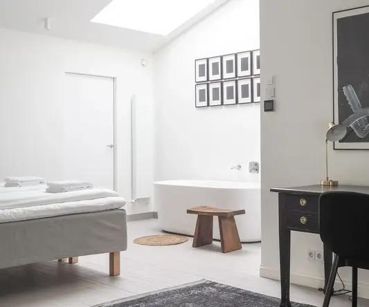 a room with a desk and a bed